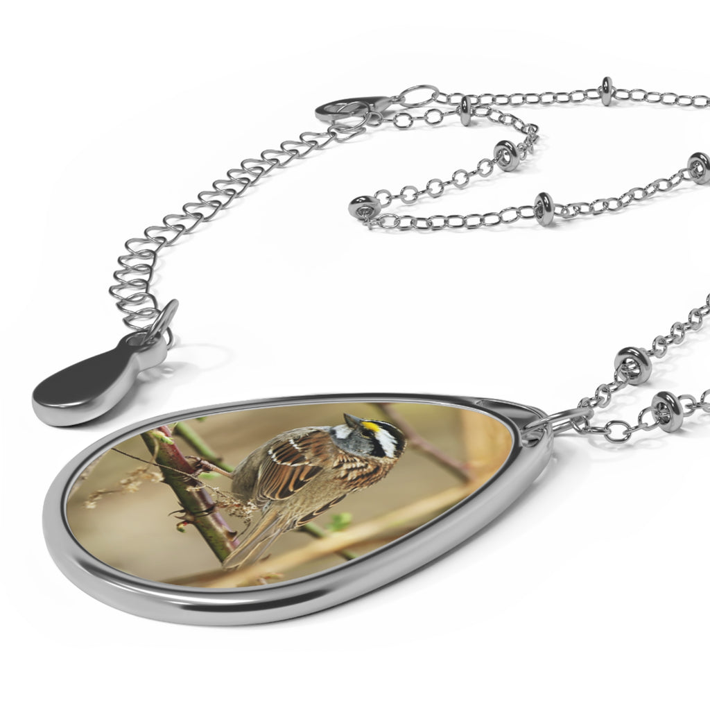 Teardrop-shaped pendant with a white-throated sparrow photo