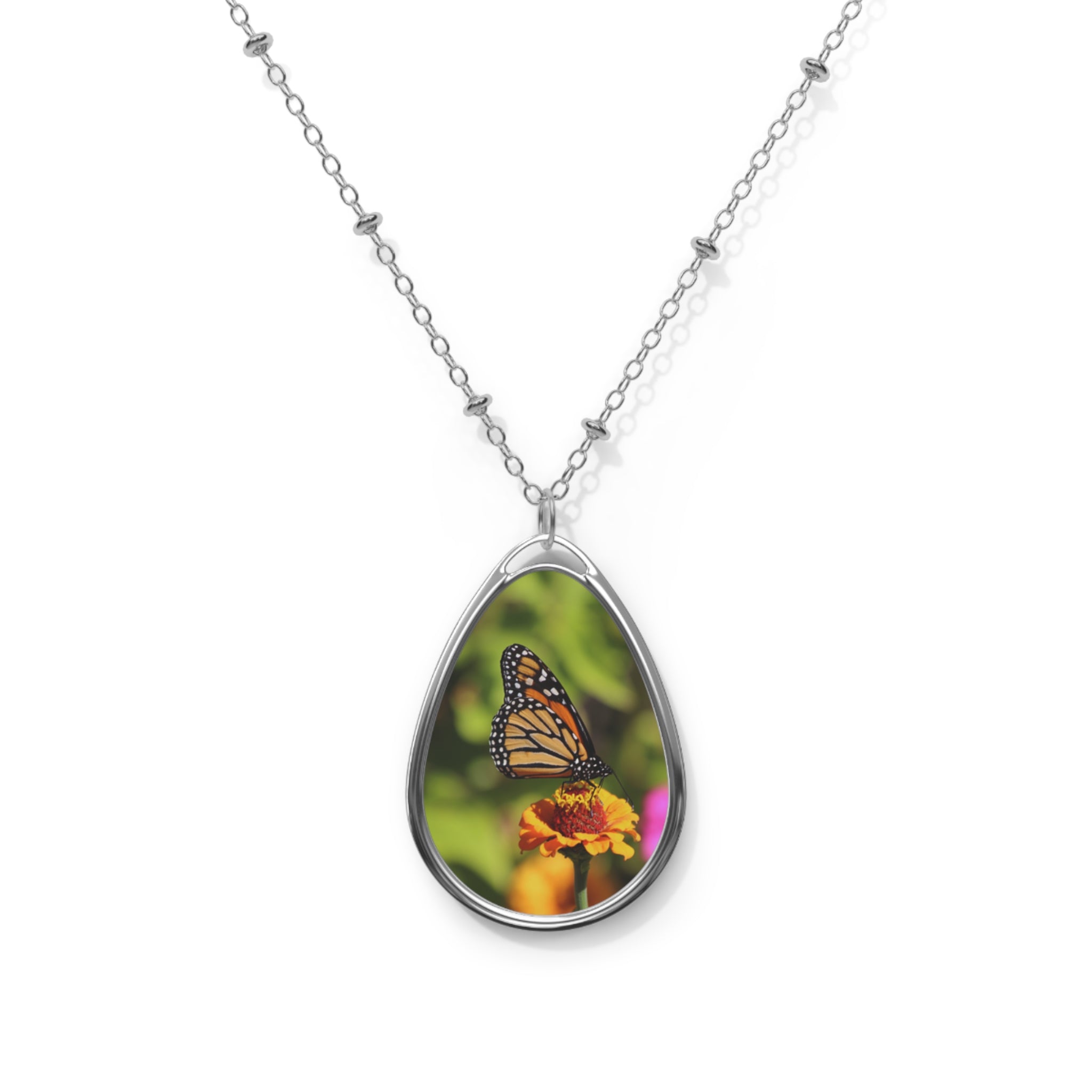 Teardrop-shaped pendant with a monarch butterfly photo