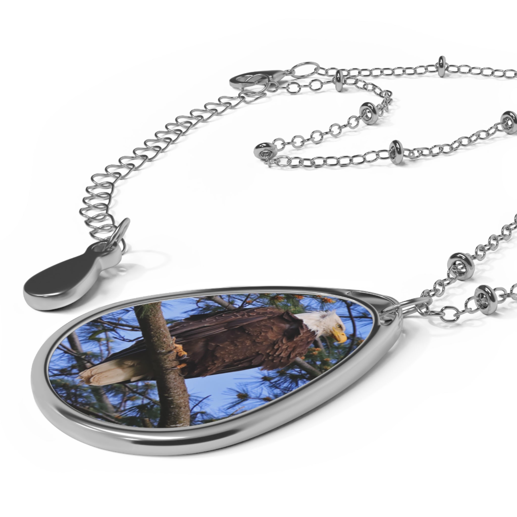 Teardrop-shaped pendant with a bald eagle photo