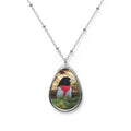 Teardrop-shaped pendant with a rose-breasted grosbeak photo
