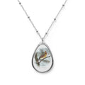 Teardrop-shaped pendant with a female northern cardinal photo