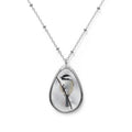 Teardrop-shaped pendant with a black-capped chickadee photo