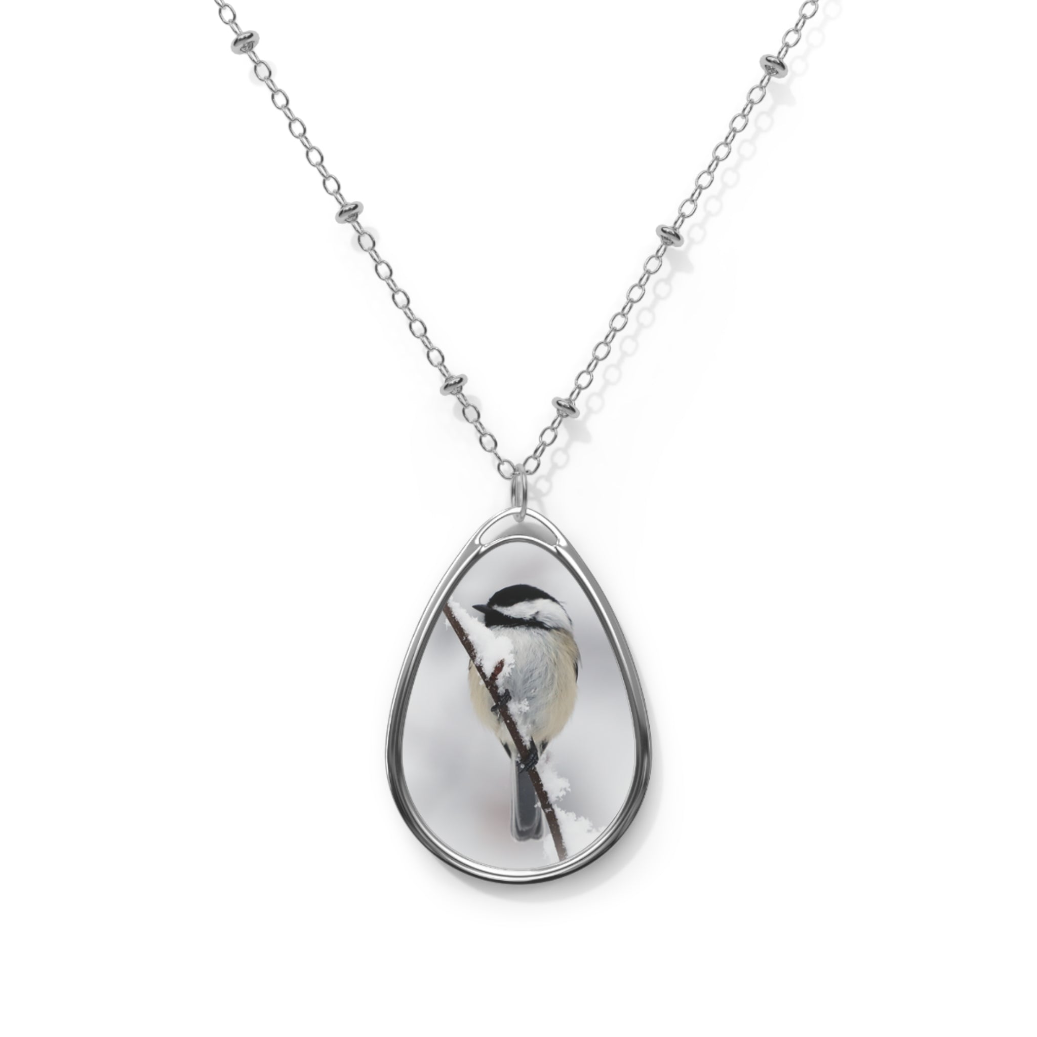 Teardrop-shaped pendant with a black-capped chickadee photo