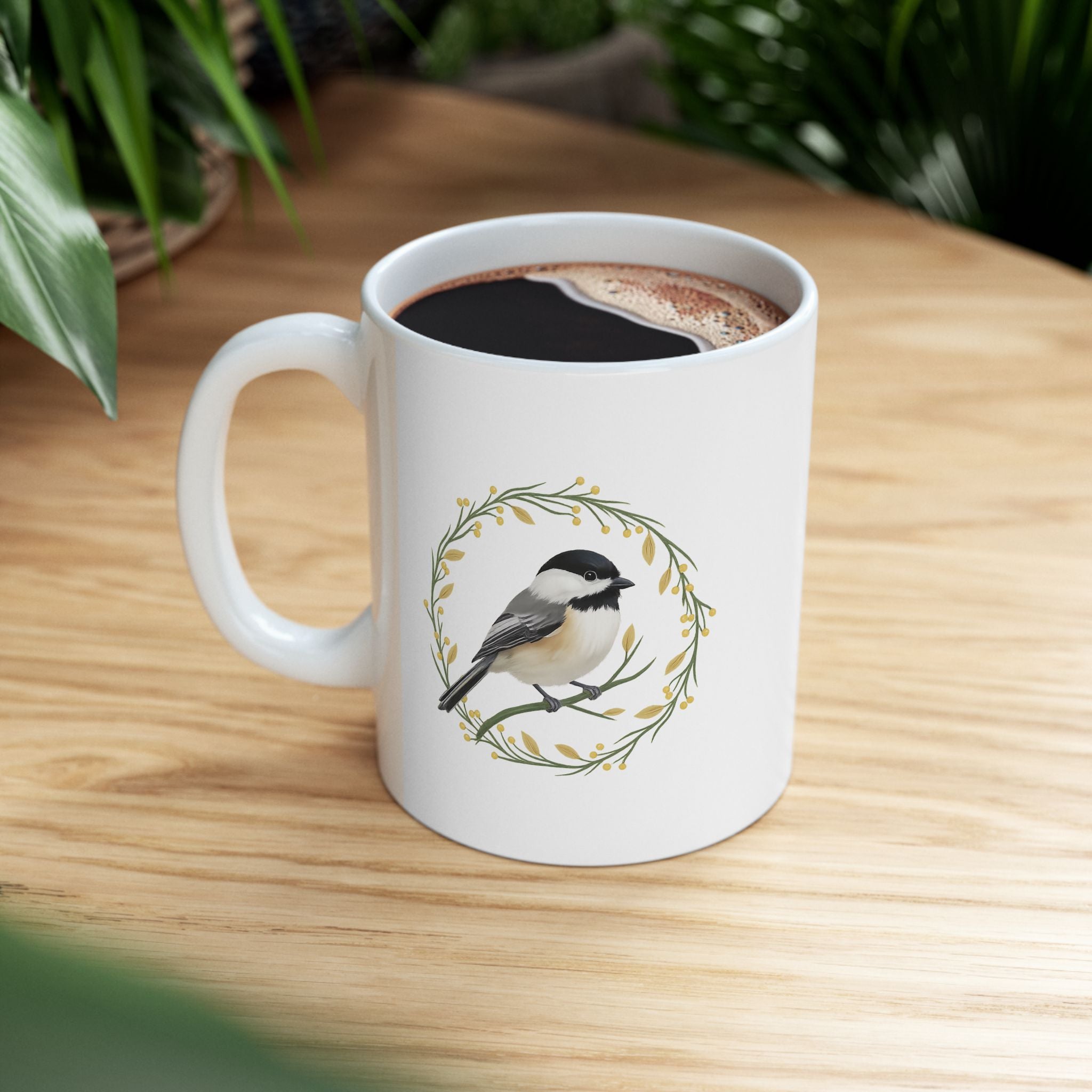 White mug with a chickadee design