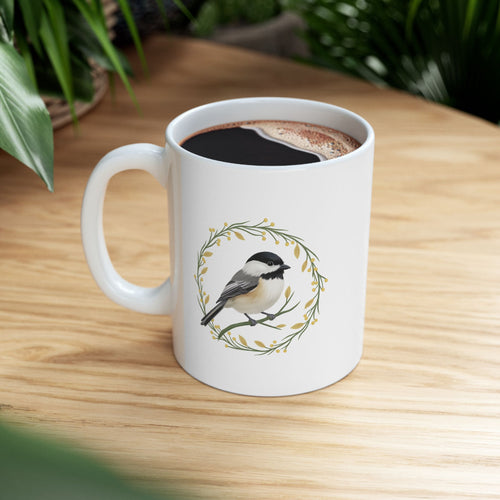 White mug with a chickadee design