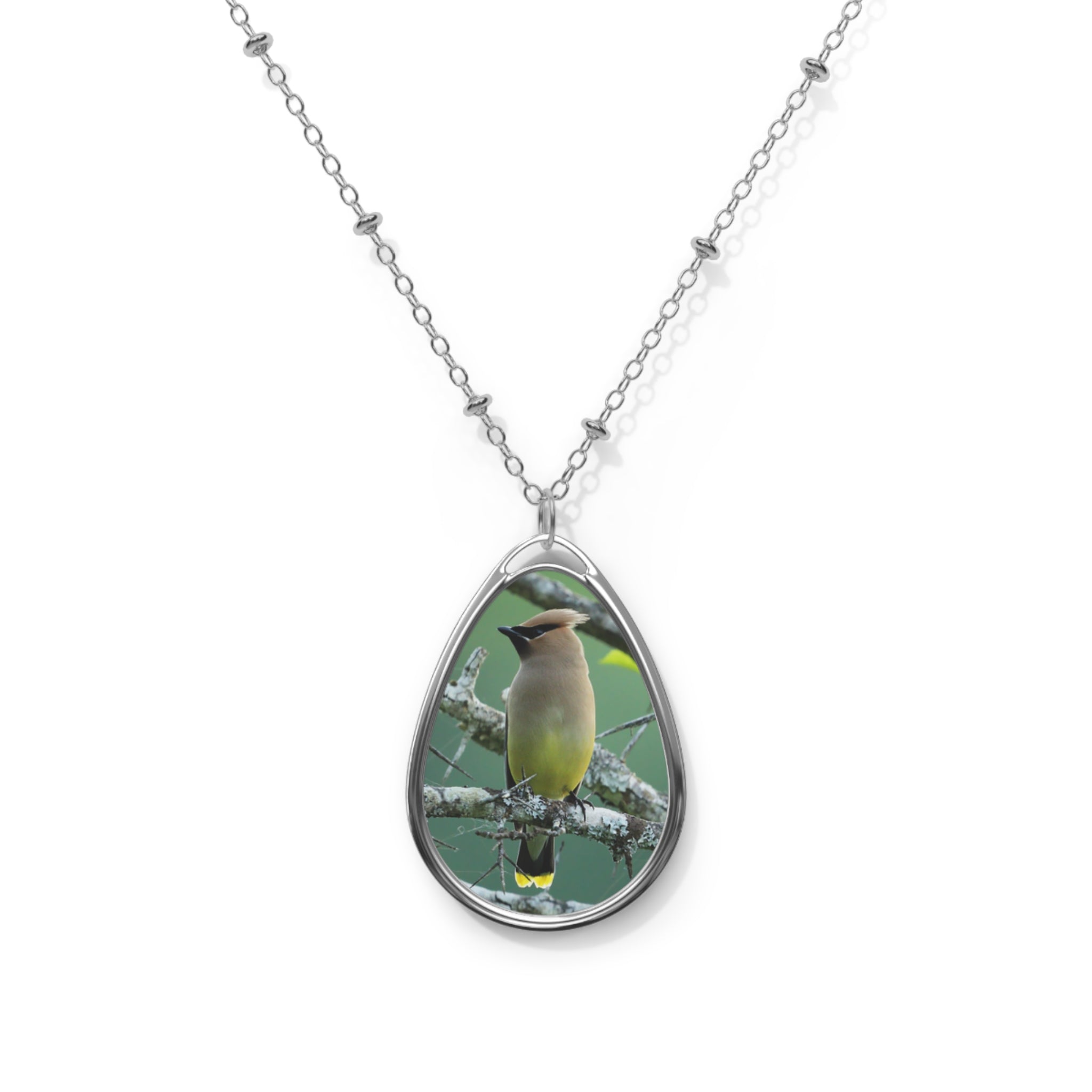 Teardrop-shaped pendant with a cedar waxwing photo