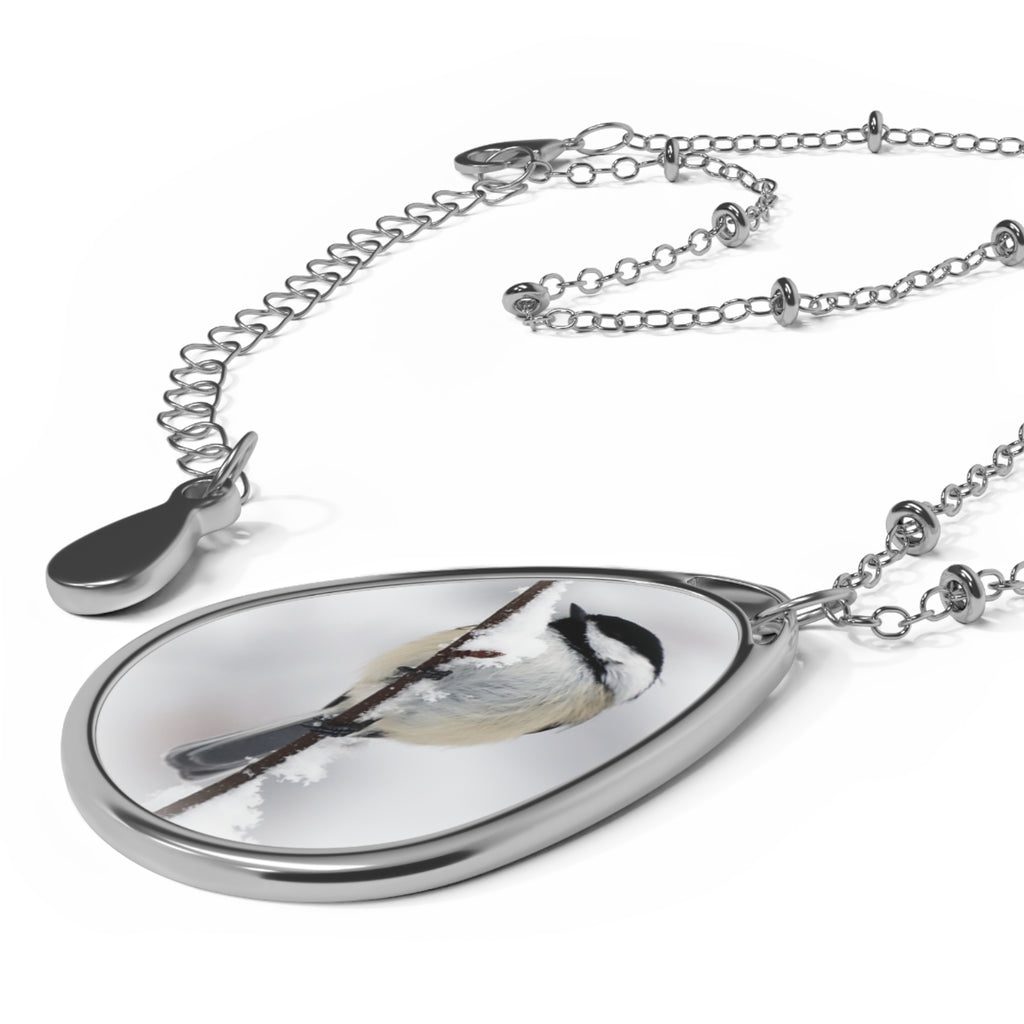Teardrop-shaped pendant with a black-capped chickadee photo