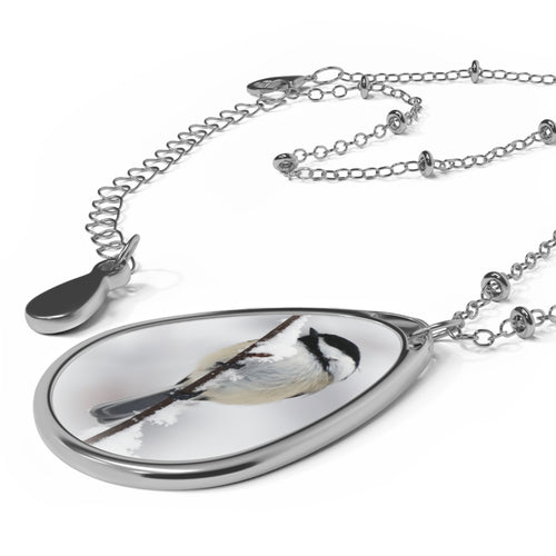 Teardrop-shaped pendant with a black-capped chickadee photo