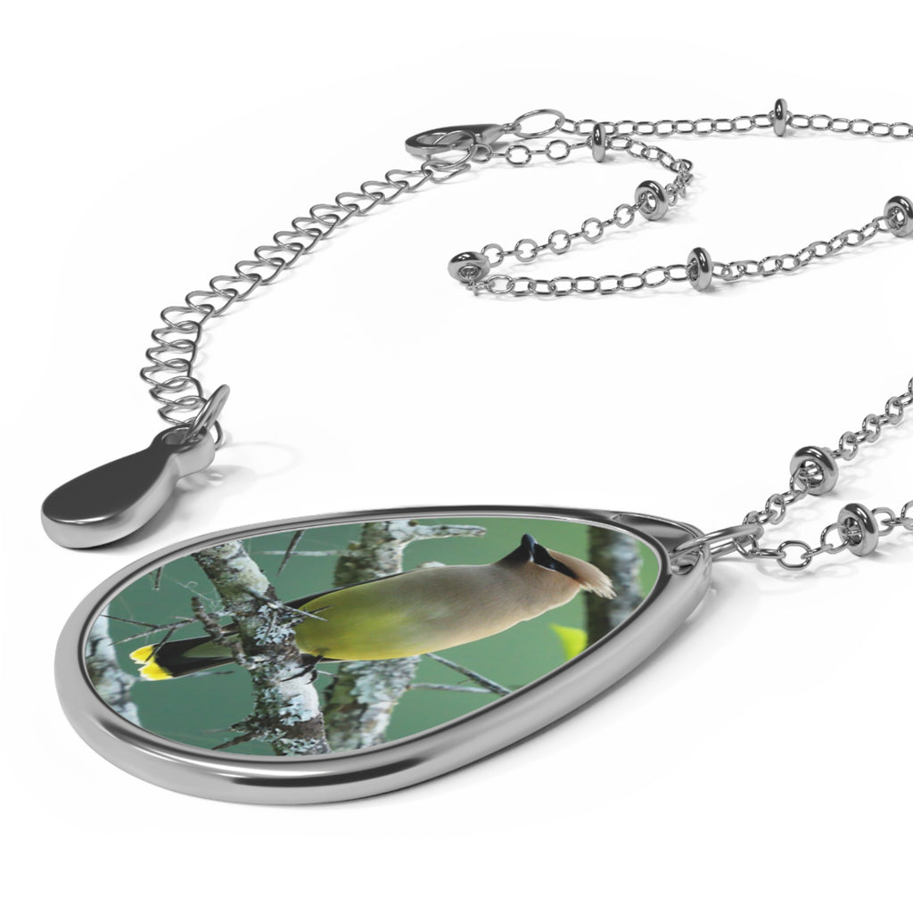 Teardrop-shaped pendant with a cedar waxwing photo