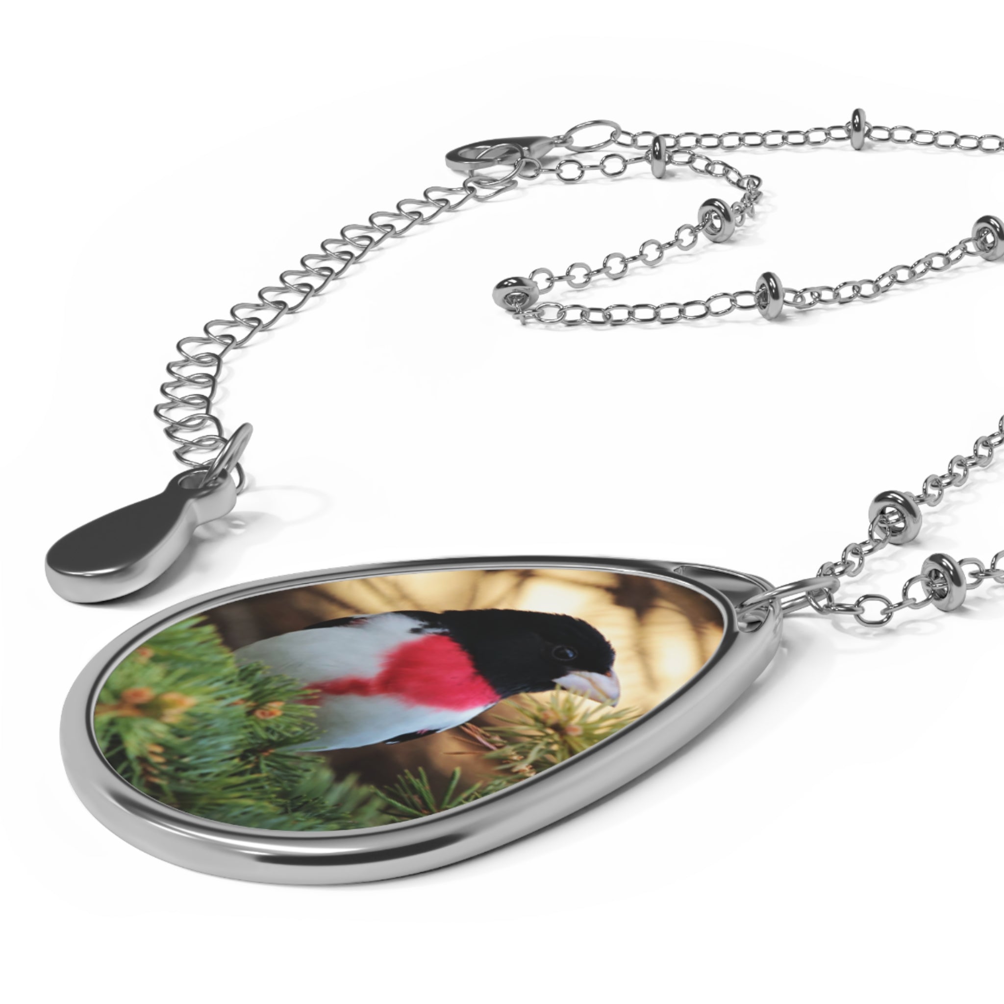 Teardrop-shaped pendant with a rose-breasted grosbeak photo