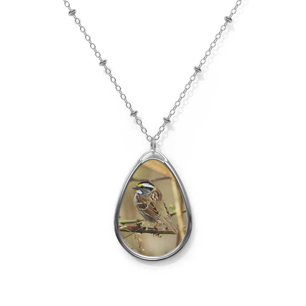 Teardrop-shaped pendant with a white-throated sparrow photo