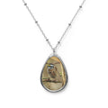 Teardrop-shaped pendant with a white-throated sparrow photo