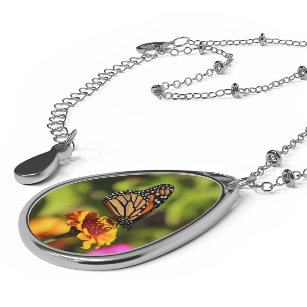 Teardrop-shaped pendant with a monarch butterfly photo
