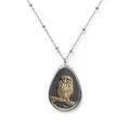 Teardrop-shaped pendant with a short- eared owl photo