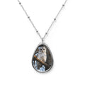 Teardrop-shaped pendant with a cedar barred owl photo